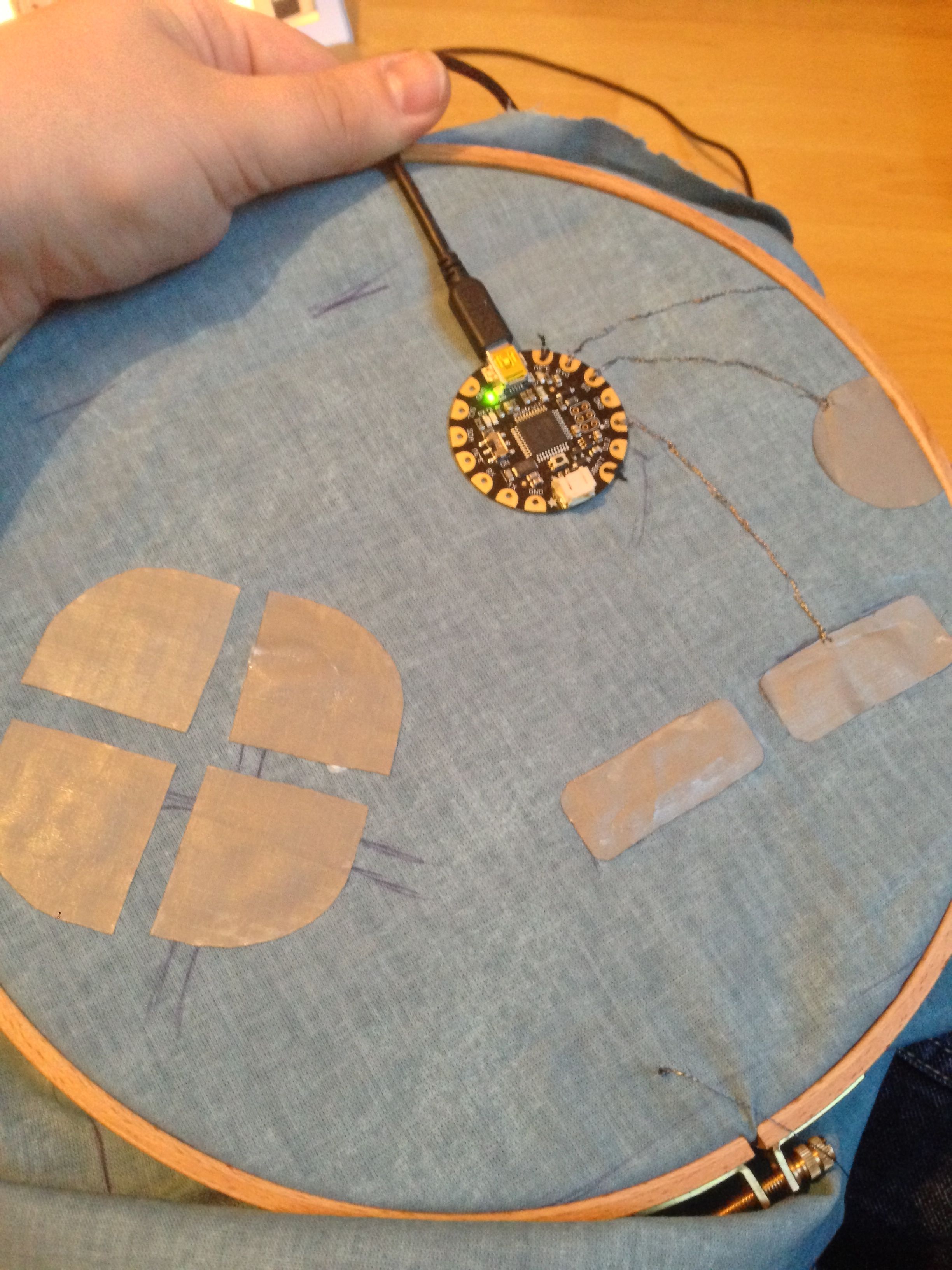 Sewing conductive threads to the flora controller and conductive fabirc pads